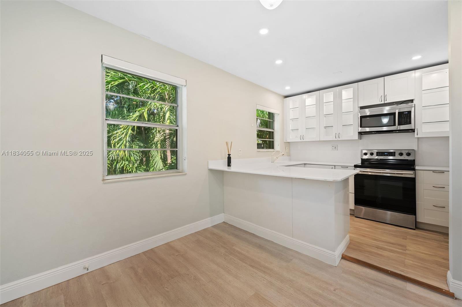 7865 Southwest 57th Avenue, Unit 48D South Miami, FL 33143 - Photo 9 of 22 a kitchen with stainless steel appliances a refrigerator and a stove top oven