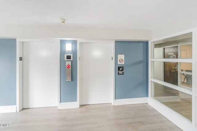 a view of a hallway with wooden floor