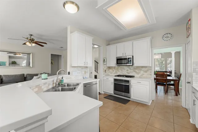 a kitchen with a sink stove and oven