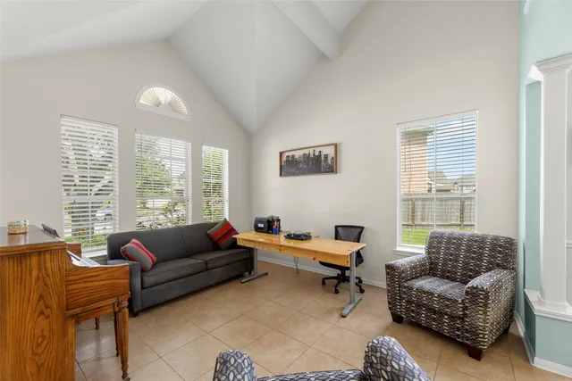 a living room with furniture ceiling fan and a window