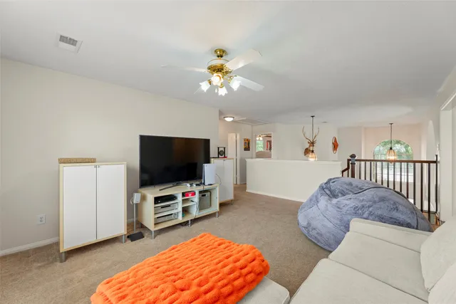 a bedroom with a bed and a ceiling fan