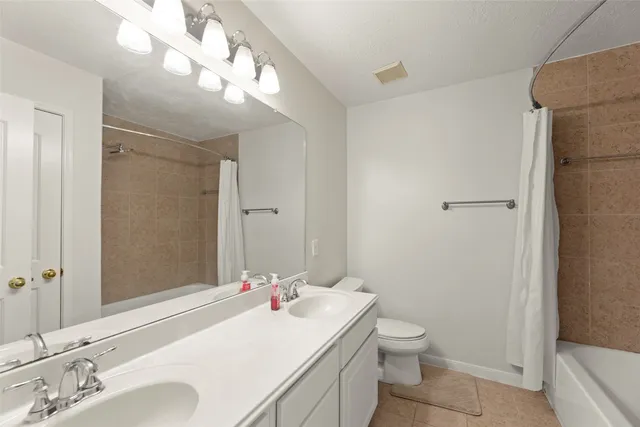 a bathroom with a sink vanity and mirror