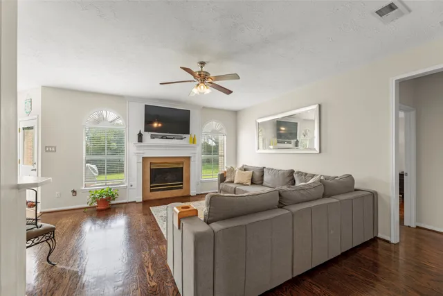 a living room with furniture a fireplace and a flat screen tv