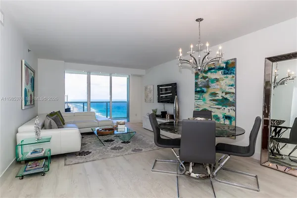a living room with furniture and a chandelier