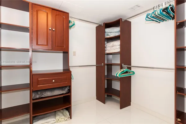 a view of walk in closet with empty racks