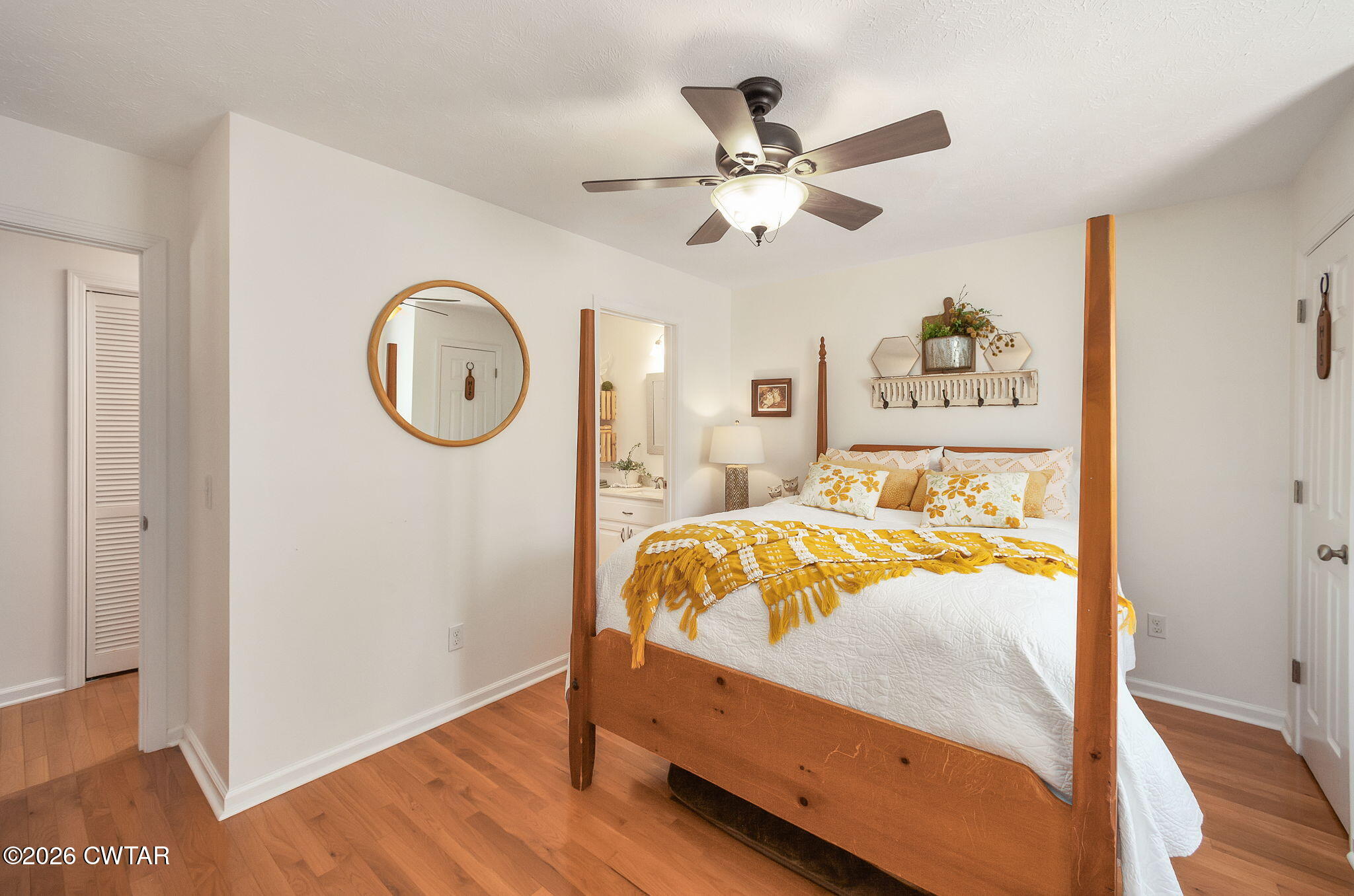455 Madison Scott Road Parsons, TN 38363 - Photo 19 of 45 a bedroom with a bed and a chandelier