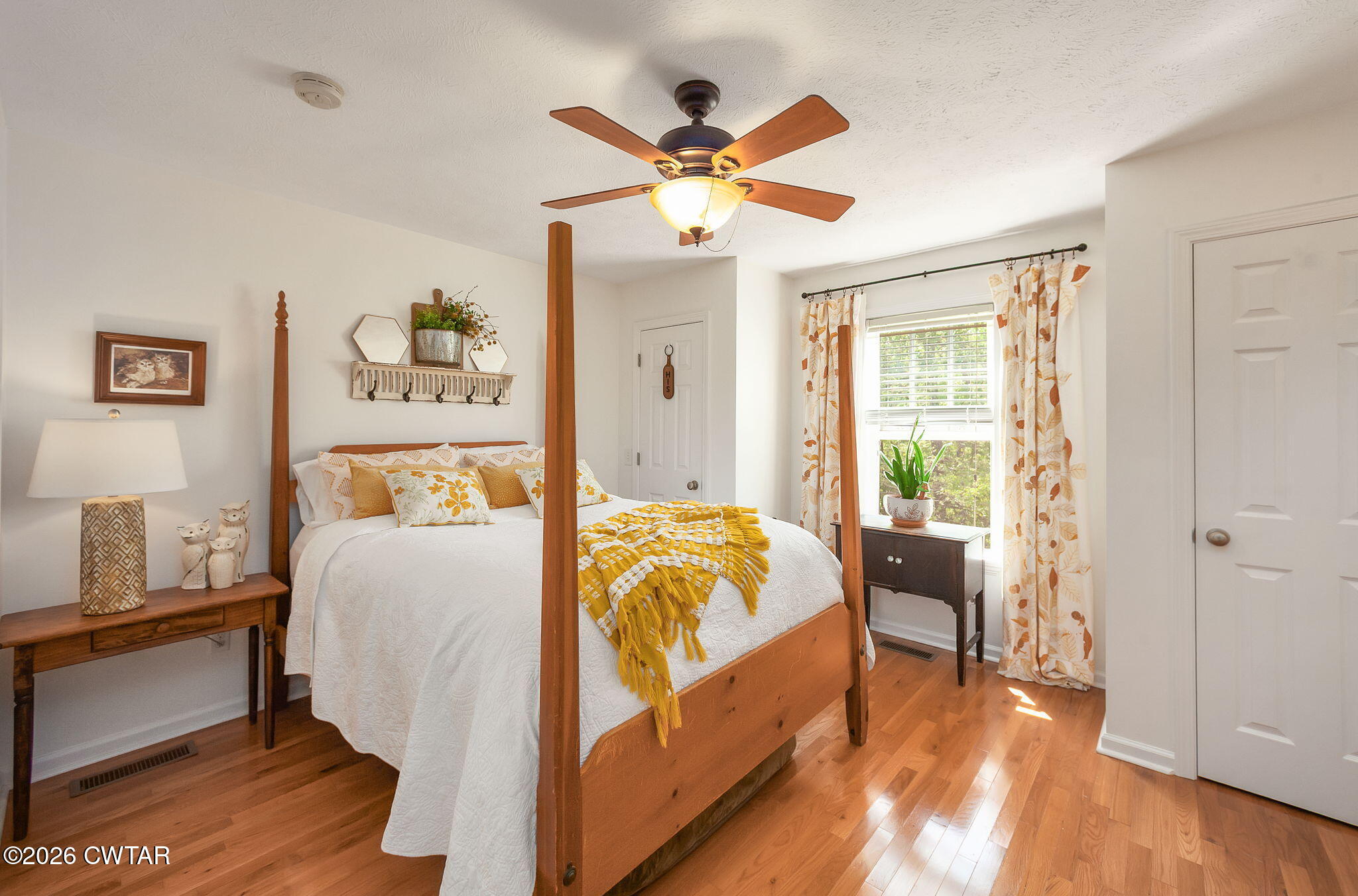 455 Madison Scott Road Parsons, TN 38363 - Photo 20 of 45 a bedroom with a bed and a chandelier