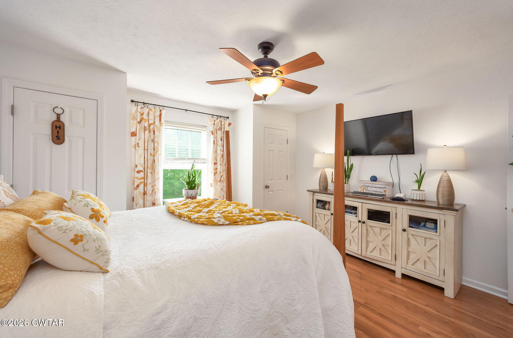455 Madison Scott Road Parsons, TN 38363 - Photo 21 of 45 a bedroom with a bed and a flat screen tv