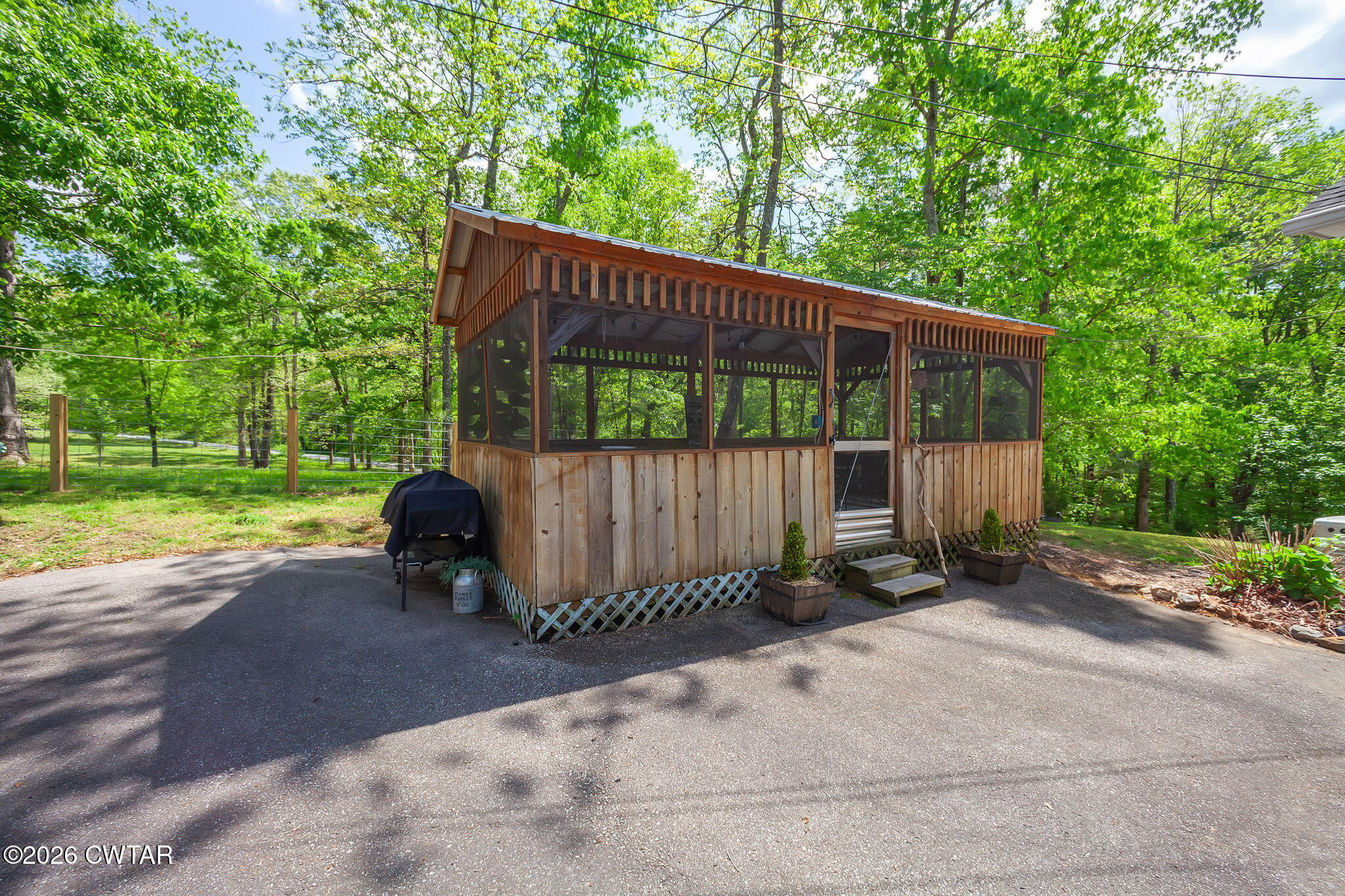 455 Madison Scott Road Parsons, TN 38363 - Photo 23 of 45 a backyard of a house with a garden and swing