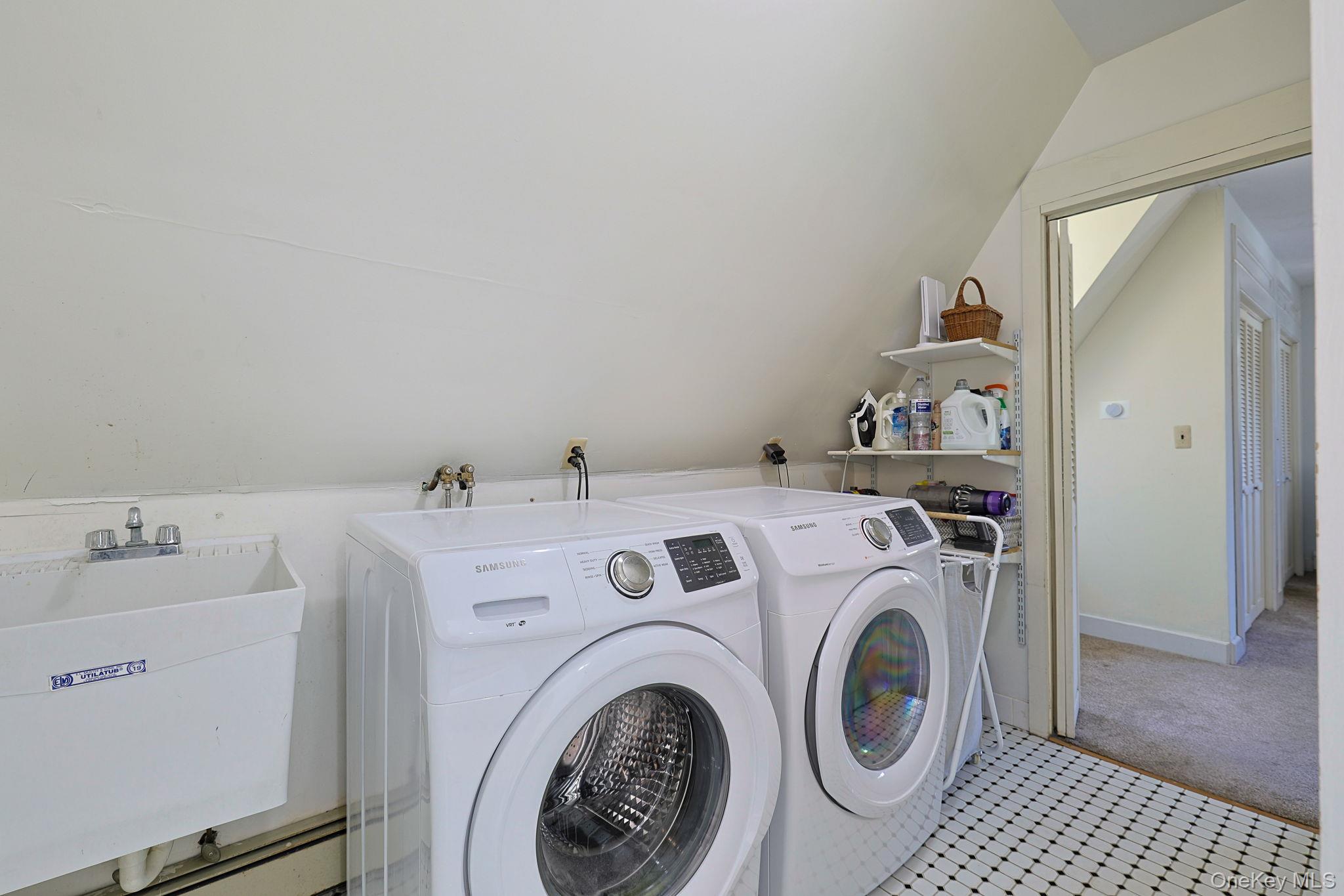 9 Library Road Tuxedo Park, NY 10987 - Photo 18 of 37 Dedicated laundry area on second floor featuring a Utility sink with a two-handle faucet, black and white mosaic tile flooring, and built-in wall shelving