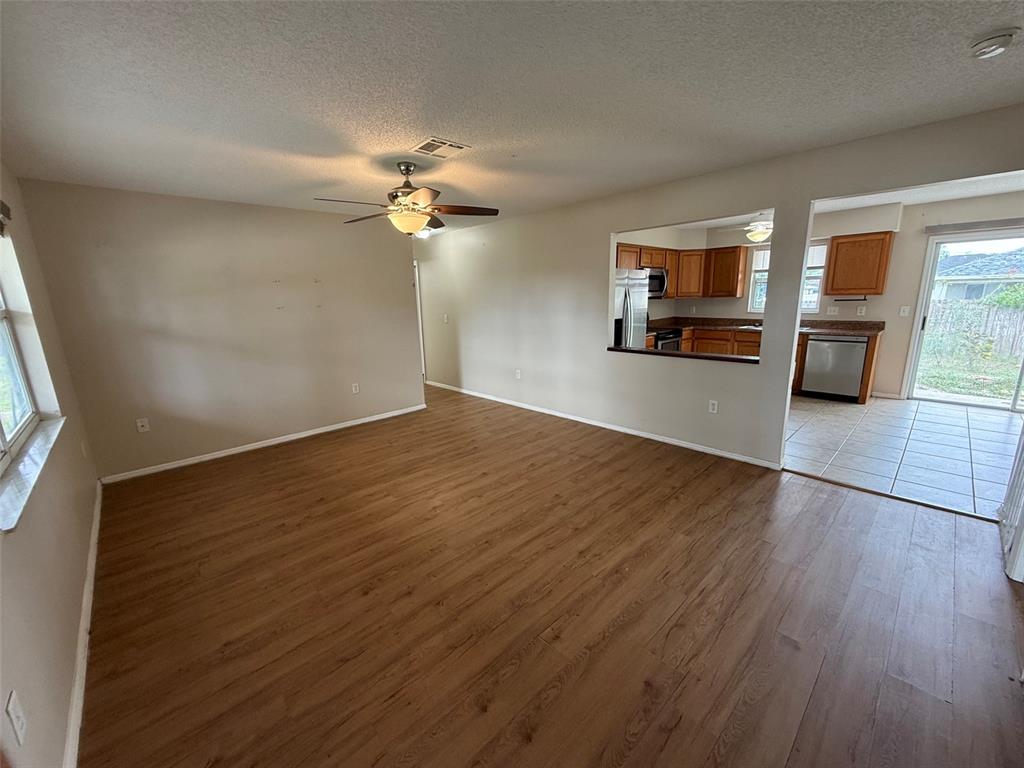 855 Jamaica Road Venice, FL 34293 - Photo 4 of 19 wooden floor in an empty room with a window