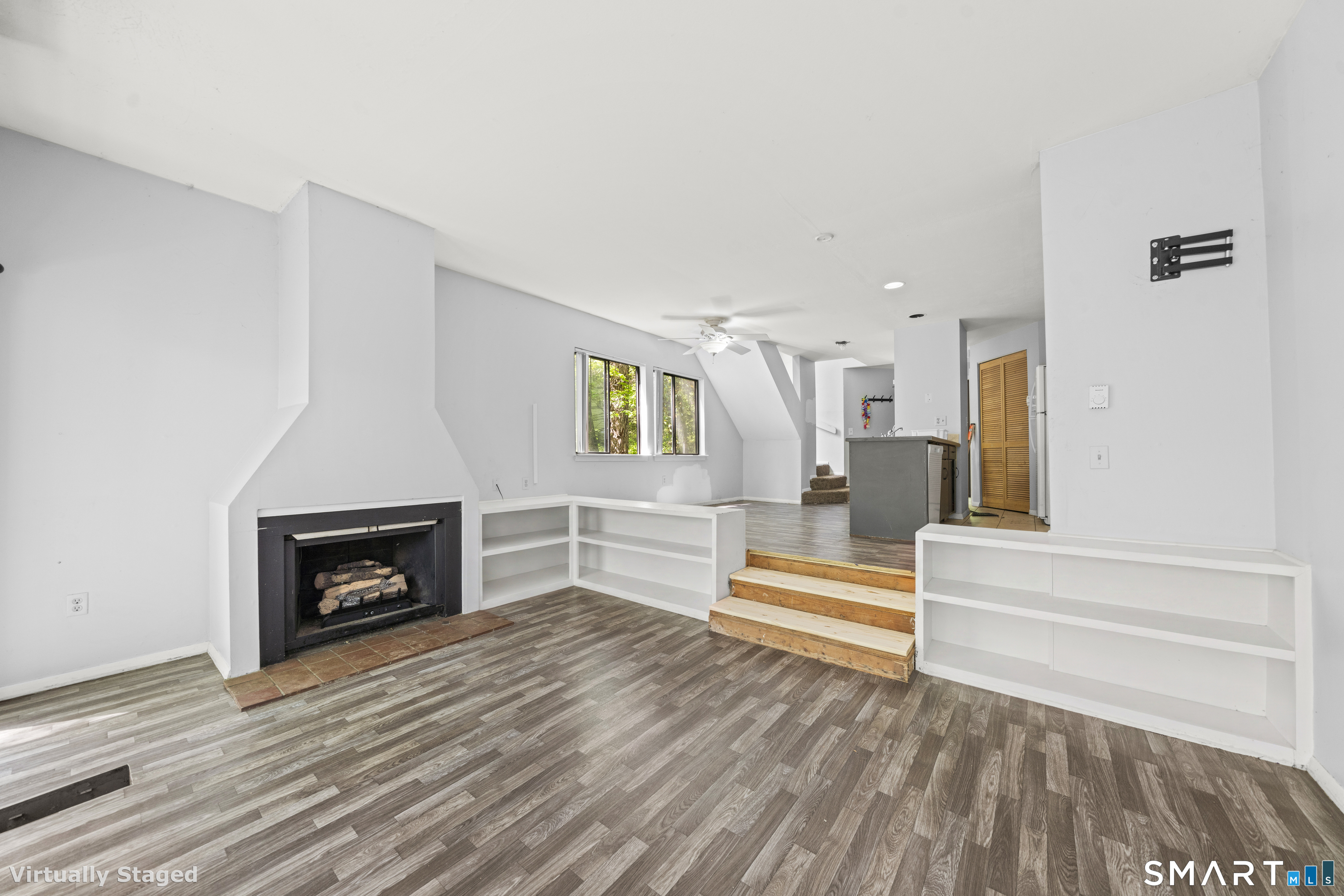 39 Evergreen Road, Unit 39 Torrington, CT 06790 - Photo 27 of 27 a an empty room with wooden floor and a fireplace