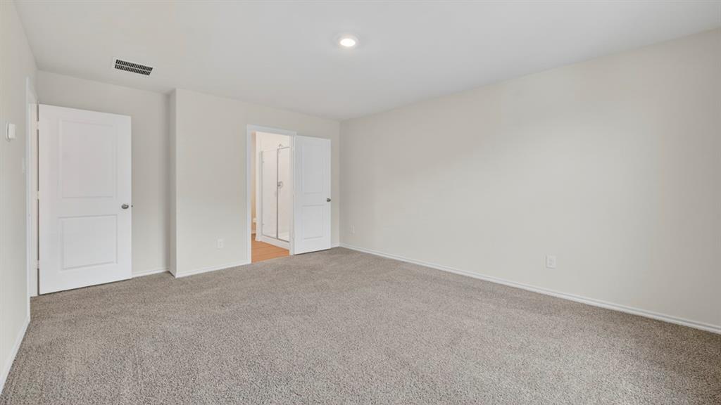 3534 Spring Time Street Forney, TX 75126 - Photo 11 of 24 Spacious room featuring neutral-toned carpeting, light-colored walls, and a recessed ceiling light