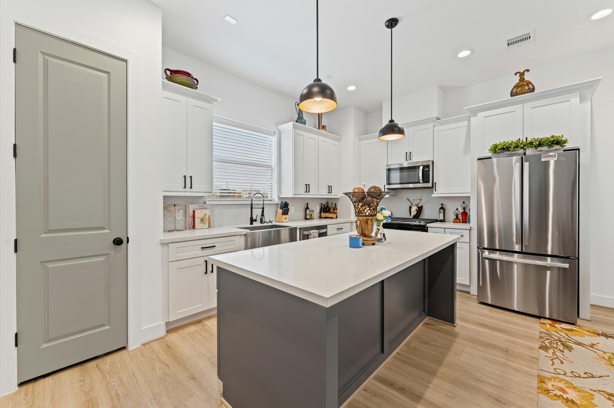 2311 Eagle Street Houston, TX 77004 - Photo 2 of 21 a kitchen with refrigerator cabinets and wooden floor
