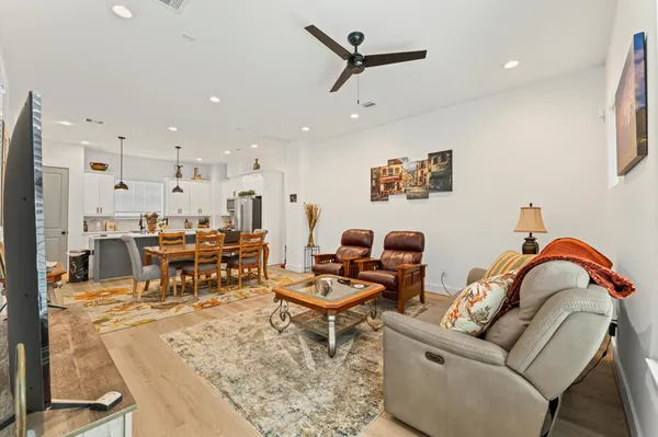a living room with furniture and kitchen view