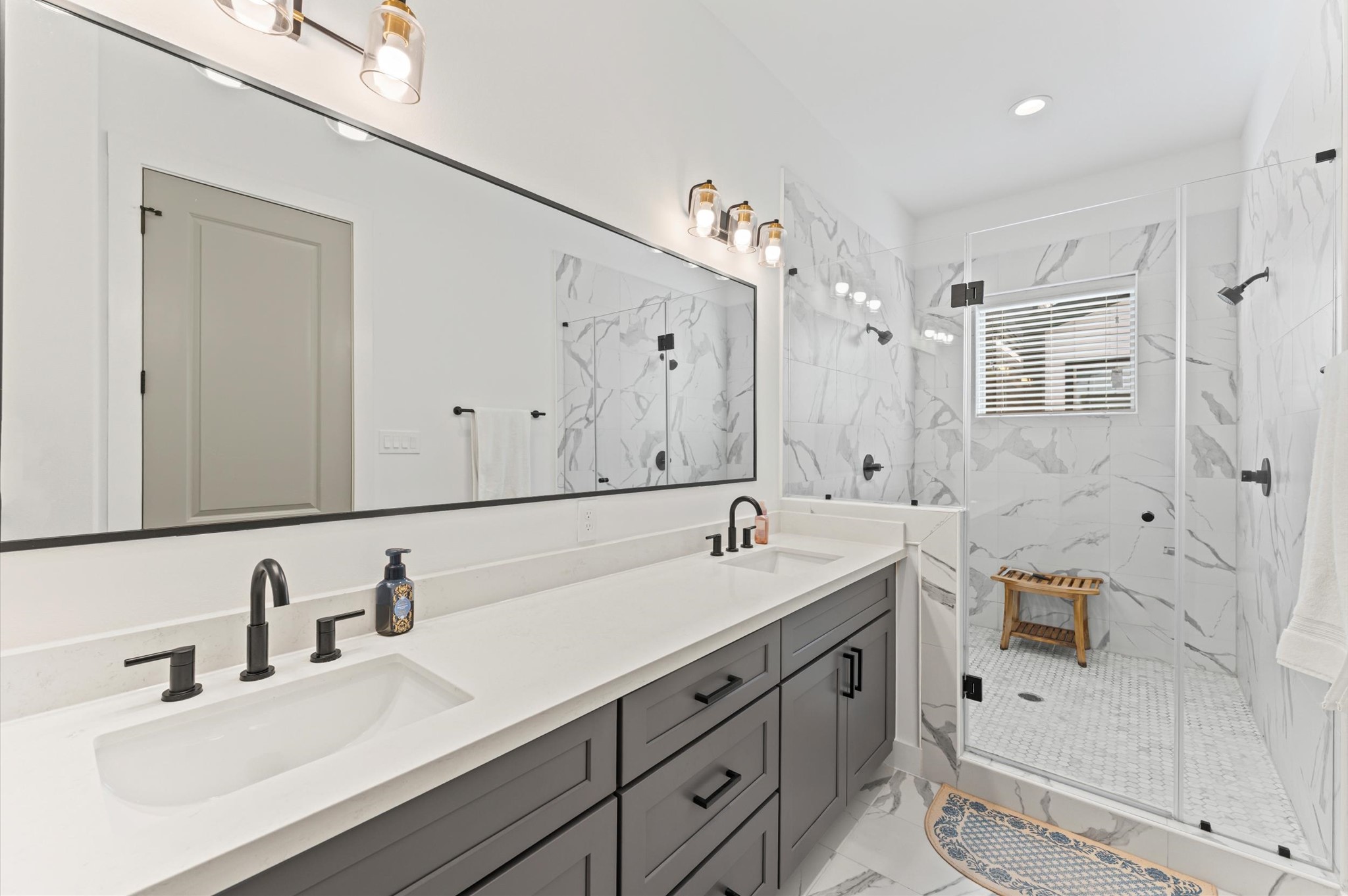 2311 Eagle Street Houston, TX 77004 - Photo 8 of 21 a bathroom with double vanity sink a mirror and shower