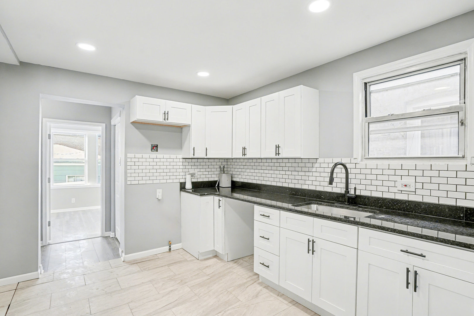 6954 South Prairie Avenue Chicago, IL 60637 - Photo 5 of 15 a kitchen with granite countertop white cabinets and white appliances