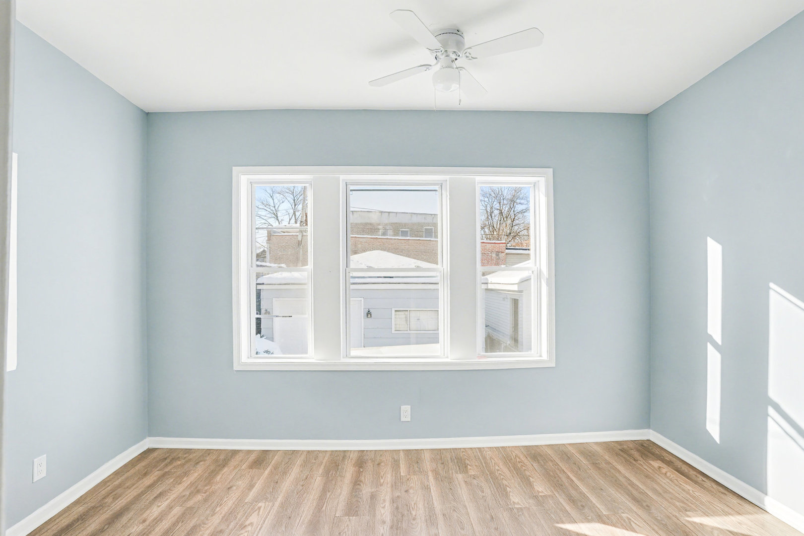 6954 South Prairie Avenue Chicago, IL 60637 - Photo 6 of 15 a view of an empty room with wooden floor and a window