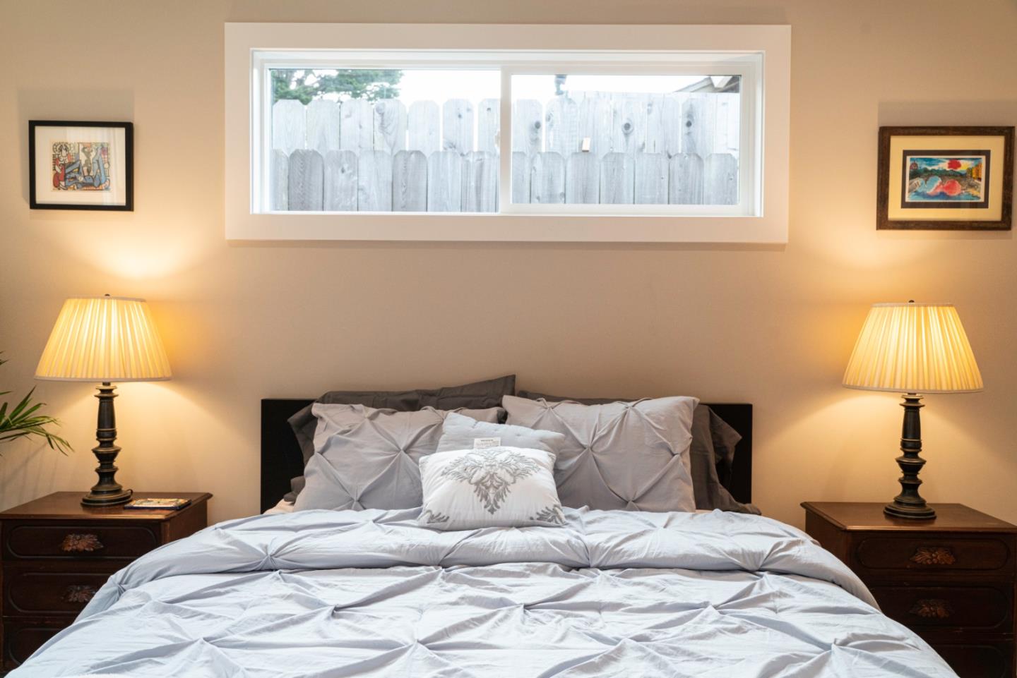 660 Edgemar Avenue Pacifica, CA 94044 - Photo 17 of 36 a bed room with a bed and a lamp