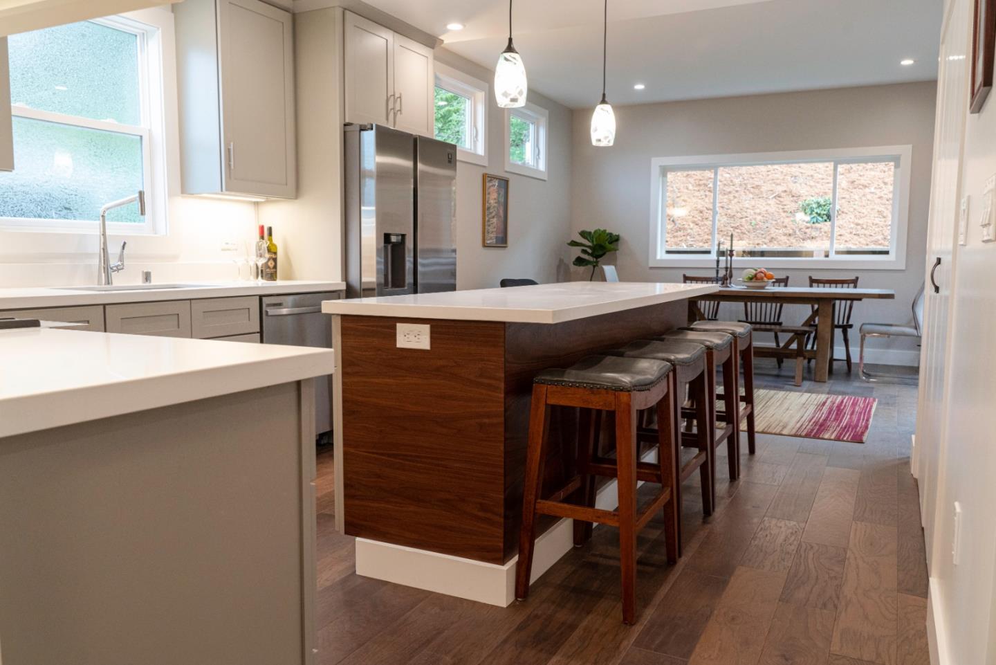 660 Edgemar Avenue Pacifica, CA 94044 - Photo 26 of 36 a kitchen with stainless steel appliances granite countertop a table chairs sink and window