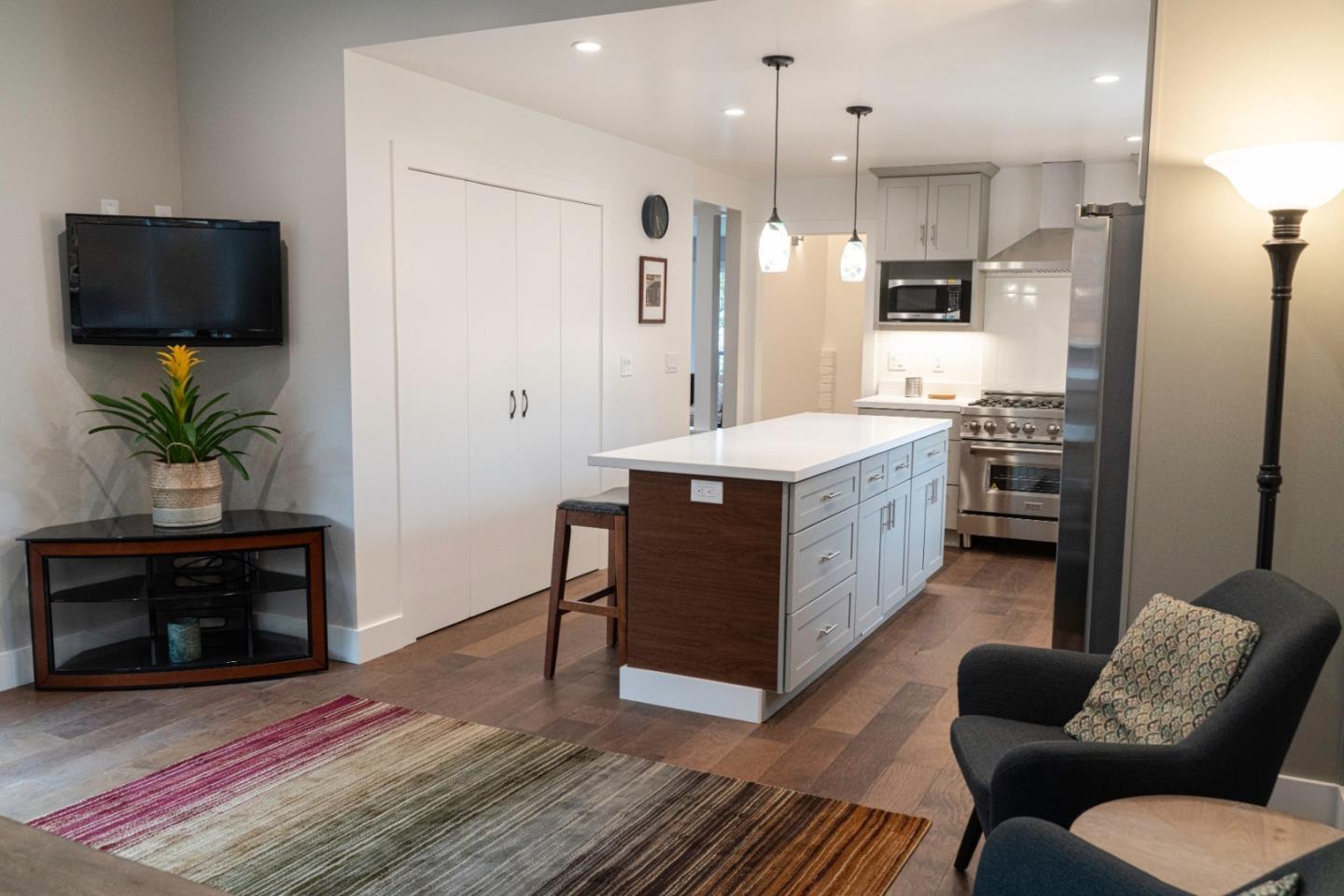 660 Edgemar Avenue Pacifica, CA 94044 - Photo 29 of 36 a kitchen with stainless steel appliances granite countertop a refrigerator a stove a sink dishwasher and a oven with wooden floor