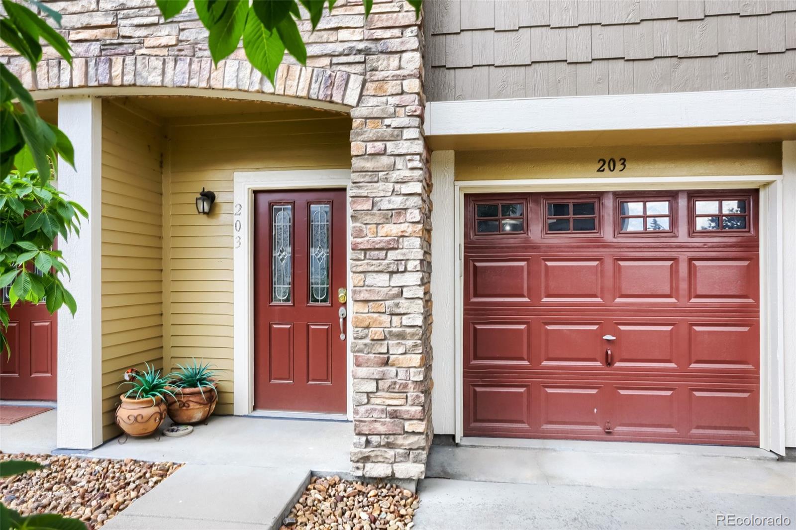 6232 Kilmer Loop, Unit 203 Golden, CO 80403 - Photo 5 of 33 a front view of a house with a garden