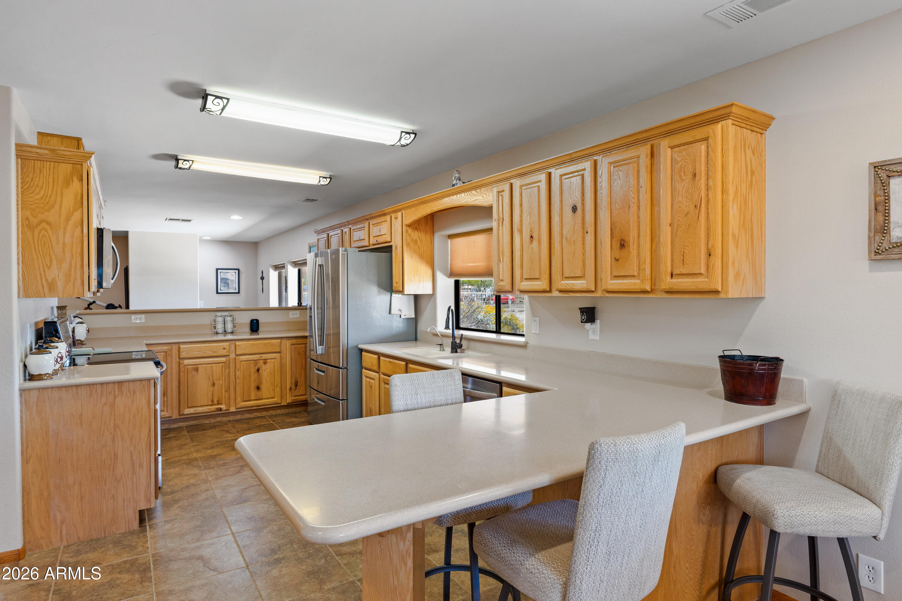 20526 West Carver Road Buckeye, AZ 85326 - Photo 16 of 43 a kitchen with a table chairs sink and cabinets