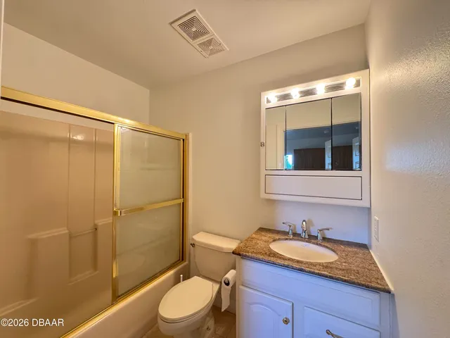 a view of a room with an empty space and a window