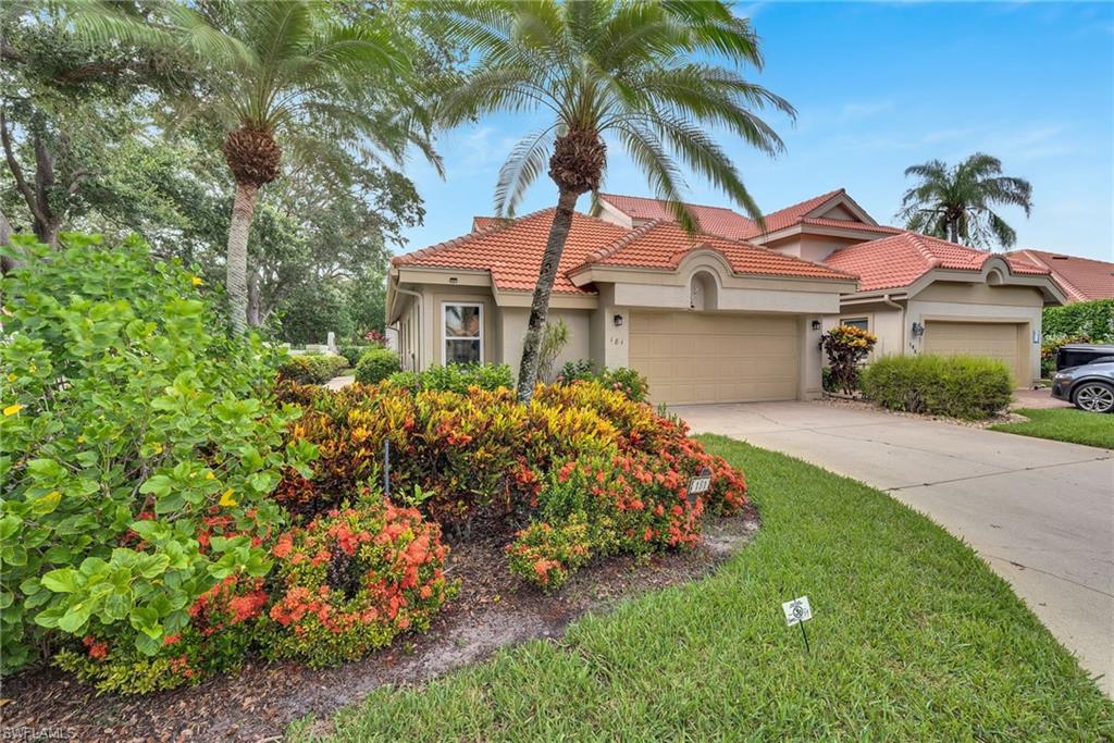 181 Napa Ridge Road East, Unit 35 Naples, FL 34119 - Photo 1 of 21 Front exterior with a tile roof and beige stucco finish