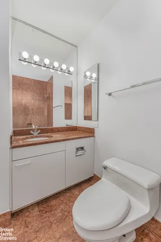 a bathroom with a toilet sink and mirror