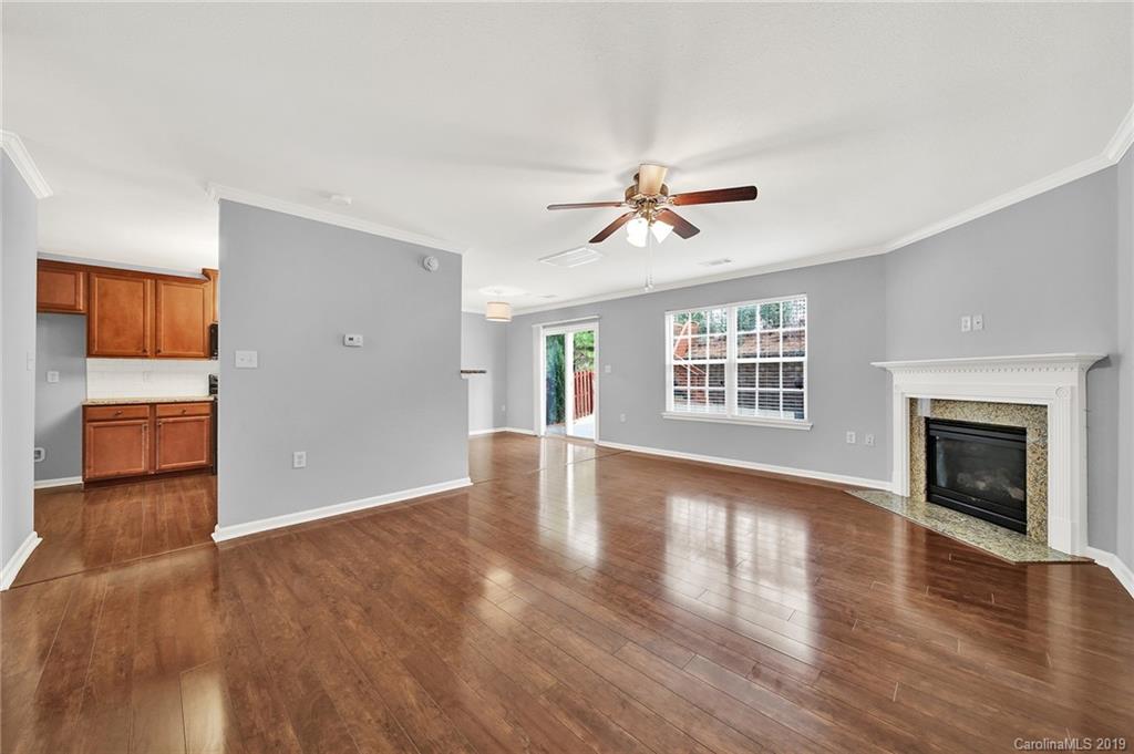 2974 Arthur Road Indian Land, SC 29707 - Photo 13 of 35 an empty room with wooden floor fireplace and windows
