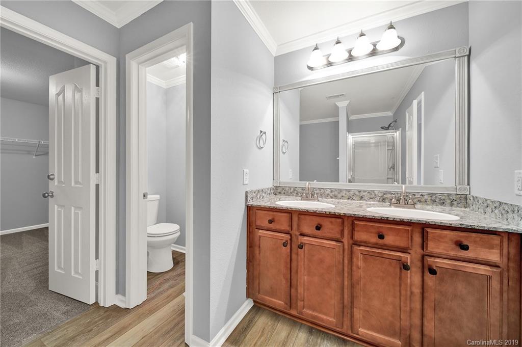 2974 Arthur Road Indian Land, SC 29707 - Photo 20 of 35 a bathroom with a granite countertop sink a mirror and a toilet