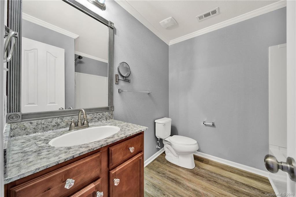 2974 Arthur Road Indian Land, SC 29707 - Photo 26 of 35 a bathroom with a granite countertop sink a toilet and a mirror