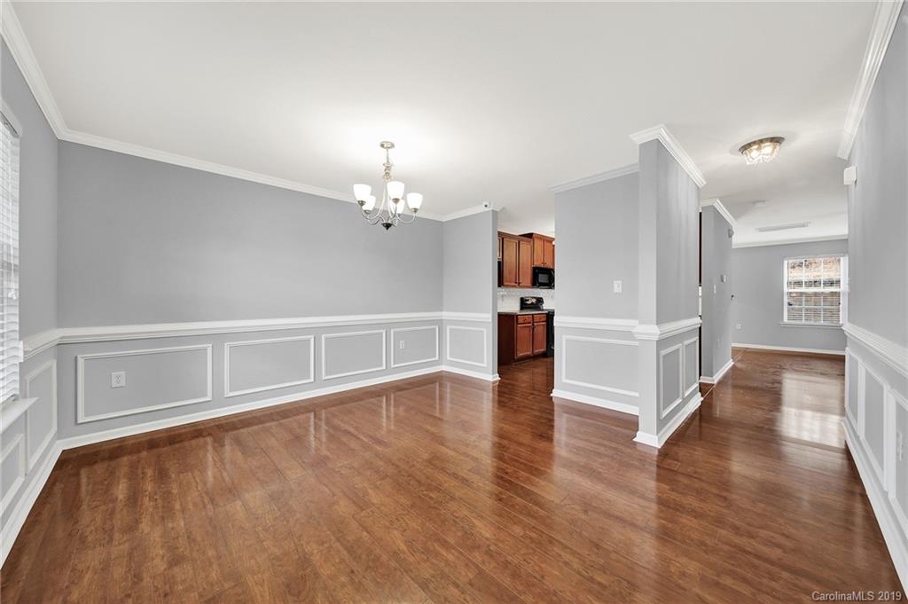 2974 Arthur Road Indian Land, SC 29707 - Photo 6 of 35 a view of an empty room with wooden floor and a kitchen