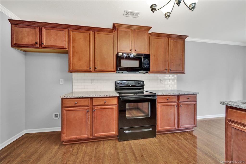 2974 Arthur Road Indian Land, SC 29707 - Photo 7 of 35 a kitchen with stainless steel appliances granite countertop a stove a sink and a microwave