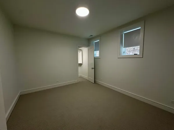 an empty room with closet and a window