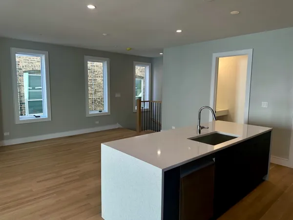 a kitchen with sink and mirror