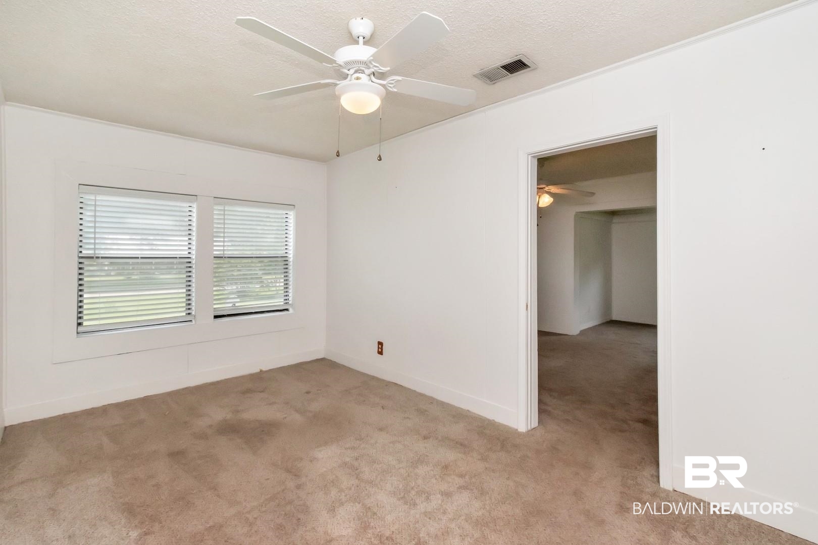12751 Zanzibar Road Grand Bay, AL 36541 - Photo 13 of 30 Carpeted spare room with a textured ceiling and ceiling fan