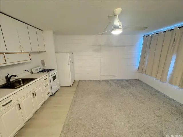 a kitchen with cabinets and white appliances