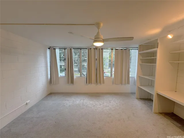 an empty room with windows and closet