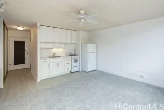 a view of kitchen with a sink cabinets and window