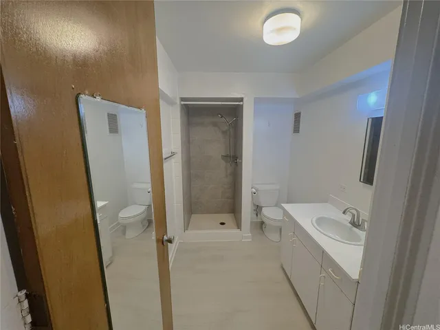a bathroom with a sink a toilet and shower
