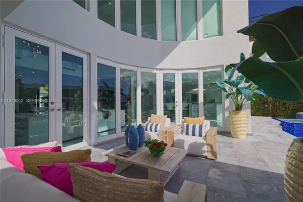 a view of living room with furniture and potted plants