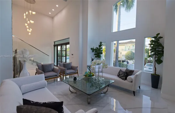 a kitchen with stainless steel appliances kitchen island granite countertop a refrigerator and a sink