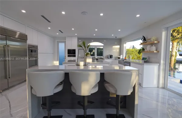 a living room with furniture and entryway