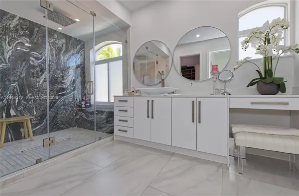 a white toilet sitting next to a bathroom sink