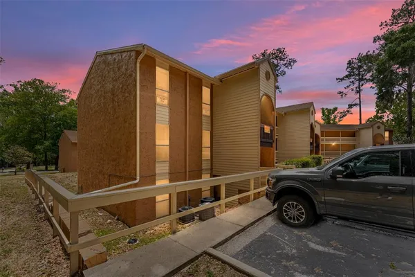 a view of a car park in front of a house