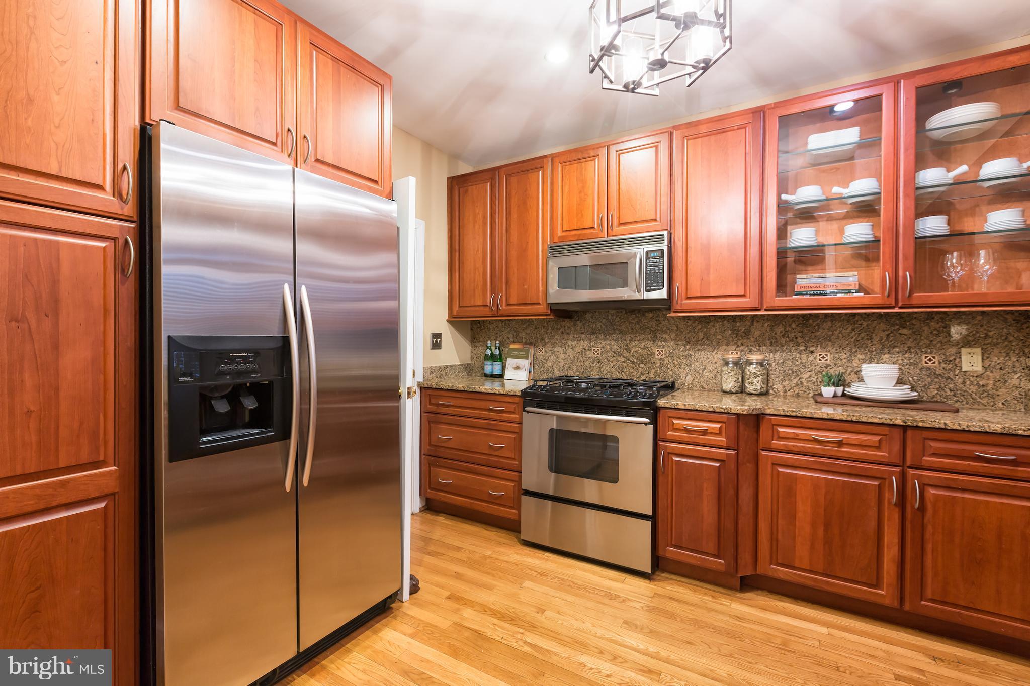 3535 R Street Northwest Washington, DC 20007 - Photo 11 of 29 a kitchen with stainless steel appliances granite countertop a refrigerator a stove a sink and dishwasher