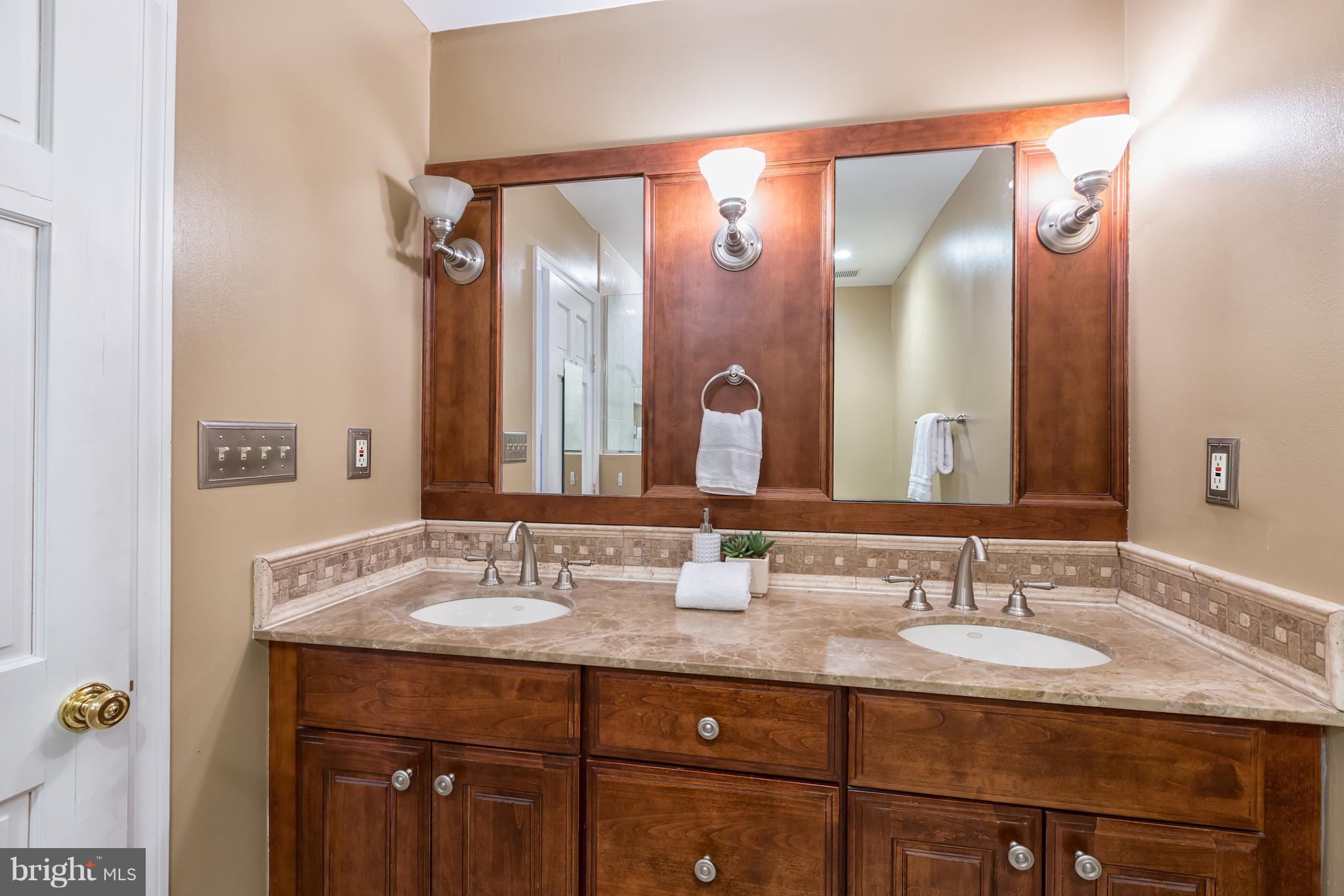 3535 R Street Northwest Washington, DC 20007 - Photo 17 of 29 a bathroom with a granite countertop sink and a mirror