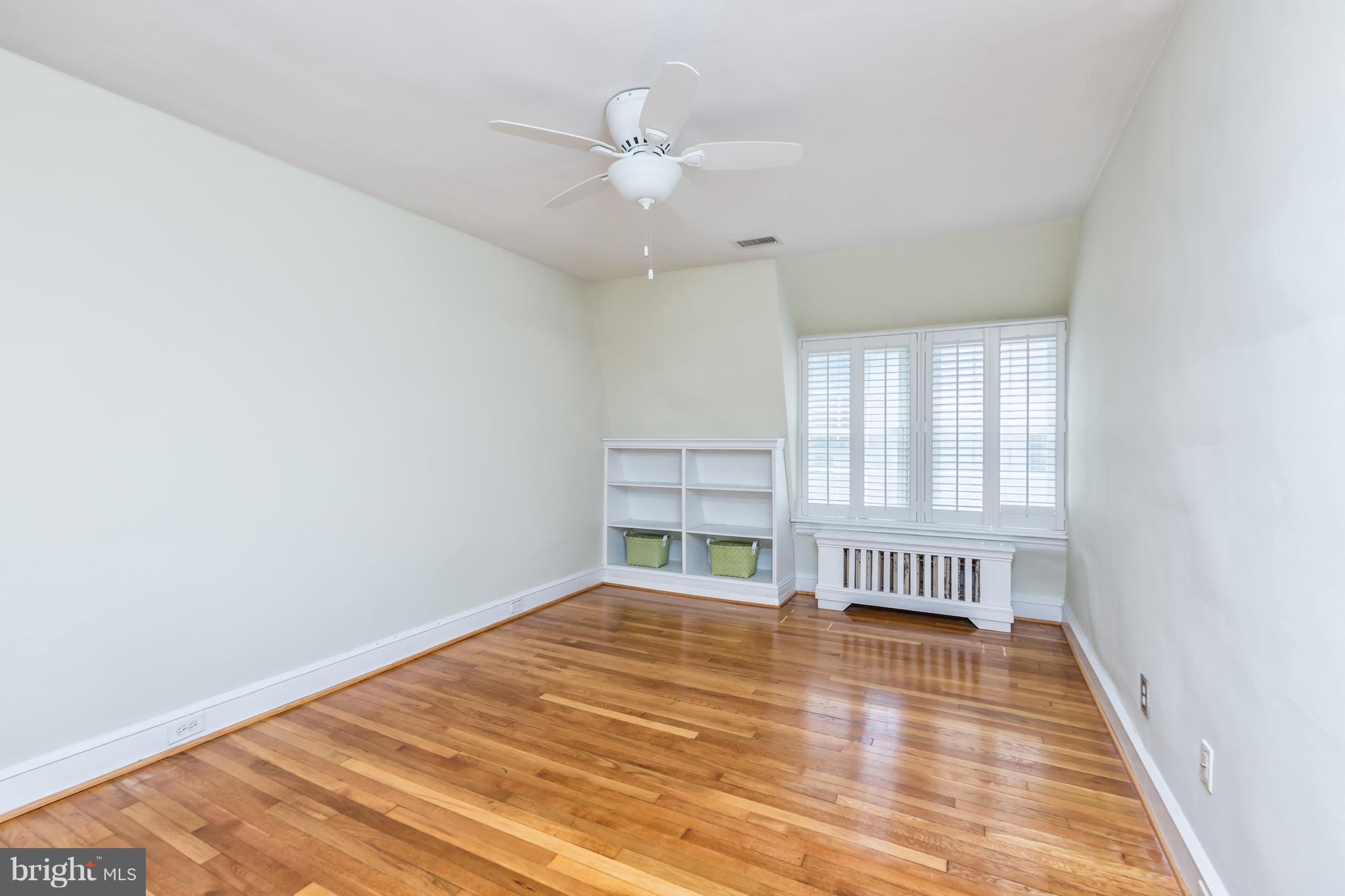 3535 R Street Northwest Washington, DC 20007 - Photo 22 of 29 wooden floor in an empty room with a window